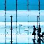 person in airport being pushed in wheelchair