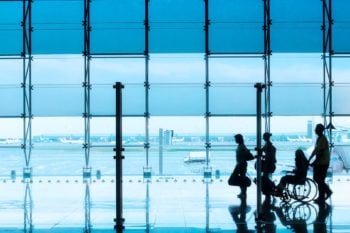 person in airport being pushed in wheelchair