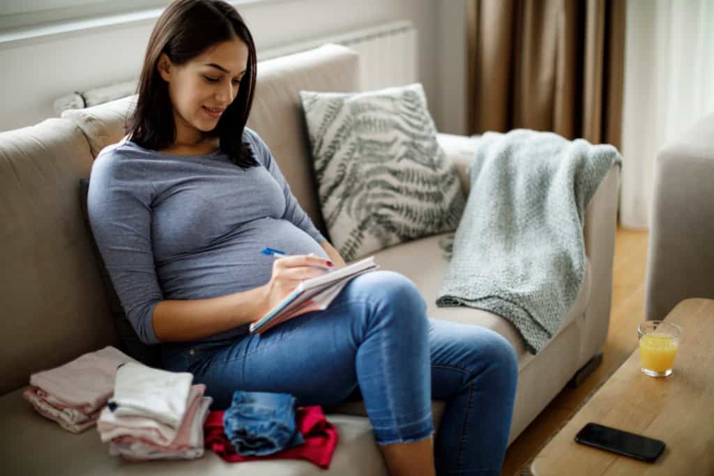 a pregnant woman making a birth plan and checking her maternity insurance for coverage benefits
