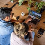 a happy couple at home booking a trip online