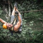 Man zipline flight in jungle