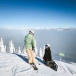 Insurance for skiers and snowboarders - two athletes at the top of the slopes