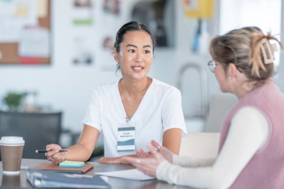 Doctor discussing care with a patient during a clinic consultation, showing the importance of having health insurance in Canada