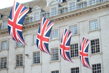 flags hanging in front of UK healthcare building