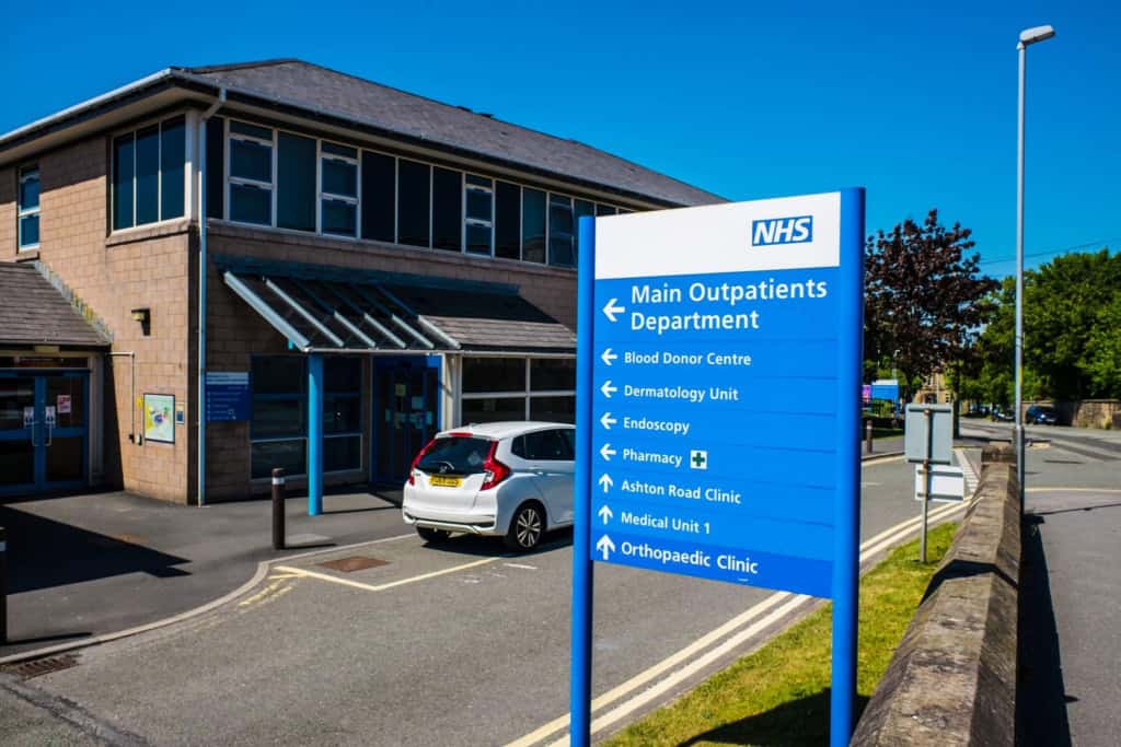 NHS outpatient department sign at Lancaster Royal Hospital where UK residents receive healthcare in the UK
