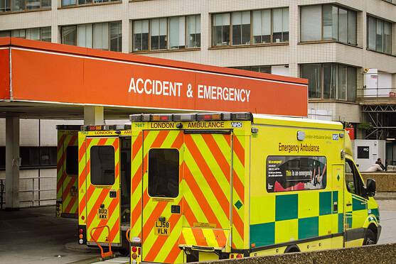 uk healthcare system shown by ambulances outsides emergency room