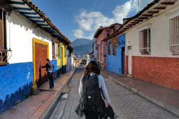 A backpacker walks by a healthcare clinic in Colombia