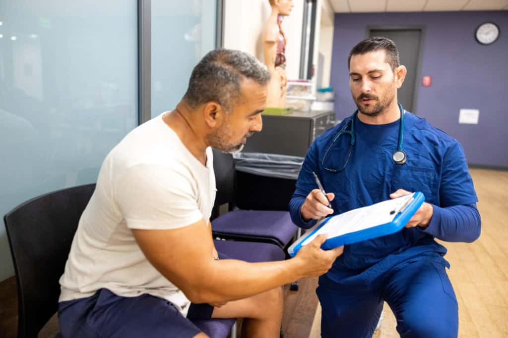 Doctor discussing ACA health insurance coverage with a non-U.S. citizen