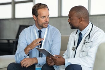 doctors in South Africa sitting together with ipad