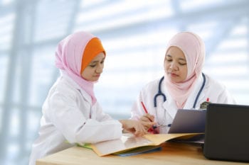 Indonesian doctor with patient