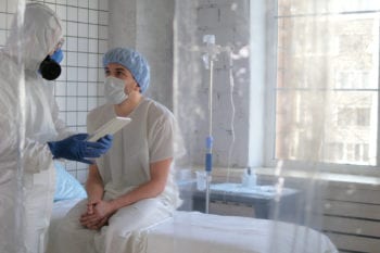 doctor speaking to patient on hospital bed