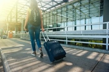 traveler with luggage and backpack