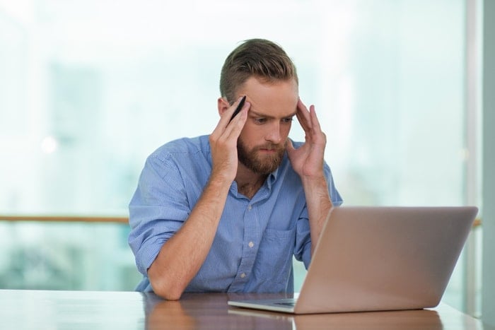 man with computer thinking about insurance