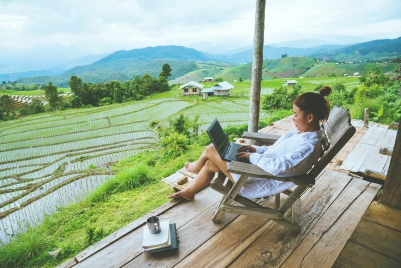 female expat working on laptop in thailand