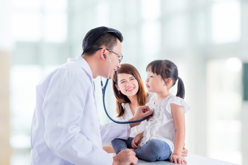 thailand doctor checking child's heartbeat