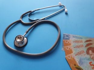 New Zealand money and stethoscope, symbolizing insurance in New Zealand for expats