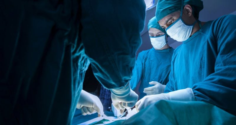 Surgeons operating on an expat