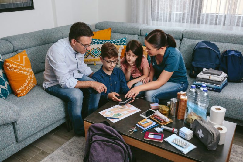 Family preparing for a natural disaster while on vacation