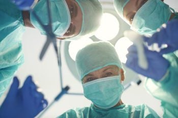 Surgeons preparing to perform surgery for expats
