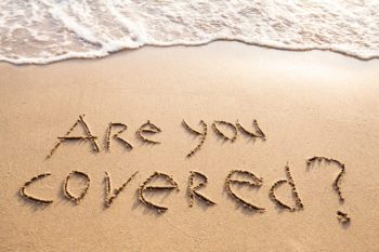 "Are you covered?" written in sand on the beach