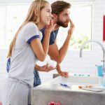 Couple in pajamas doing their skin care routine in the bathroom