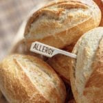 White bread rolls with a food allergy sign