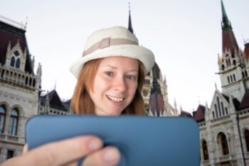 Tourist in Hungary outside Parliament building