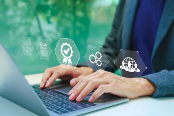 compare-international-insurance hands on a laptop keyboard using tools to compare international insurance