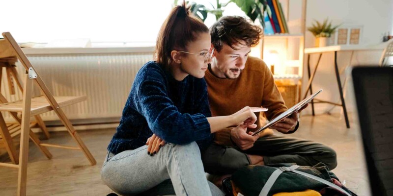 a couple creating a family budget as part of the process of moving abroad with children