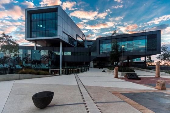 Sleek contemporary building with extensive glass windows and geometric design, showcasing a forward-thinking business environment.