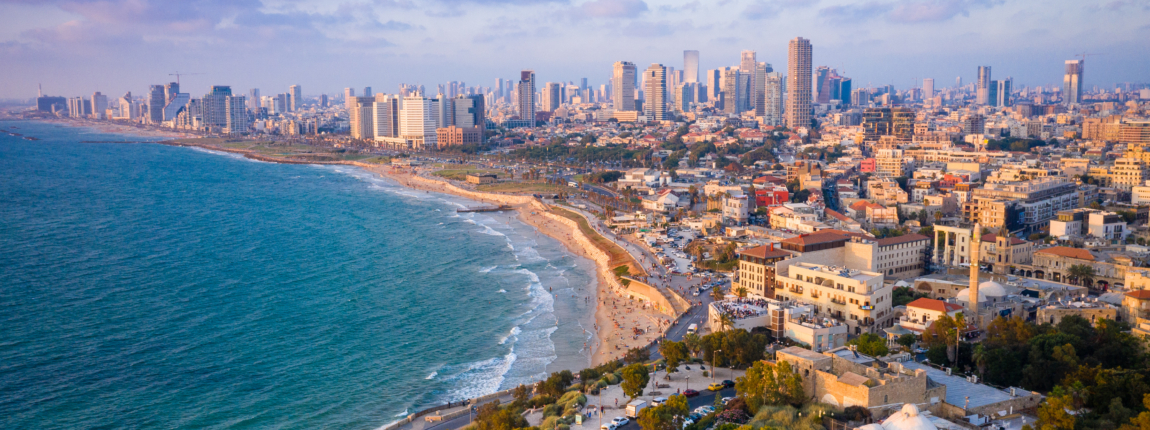 Beautiful aerial view of a vibrant coastal city with beach and skyline, ideal for highlighting international lifestyles and insurance solutions for global citizens.