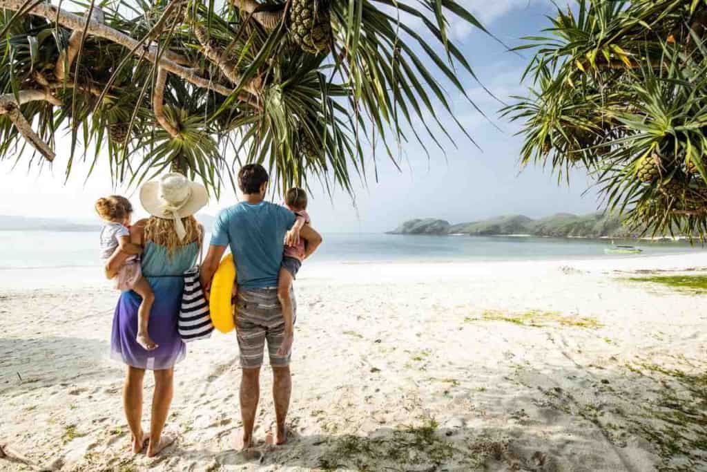a family walking on a beach on Nikoi Island in Indonesia, one of the best family vacation ideas for 2026