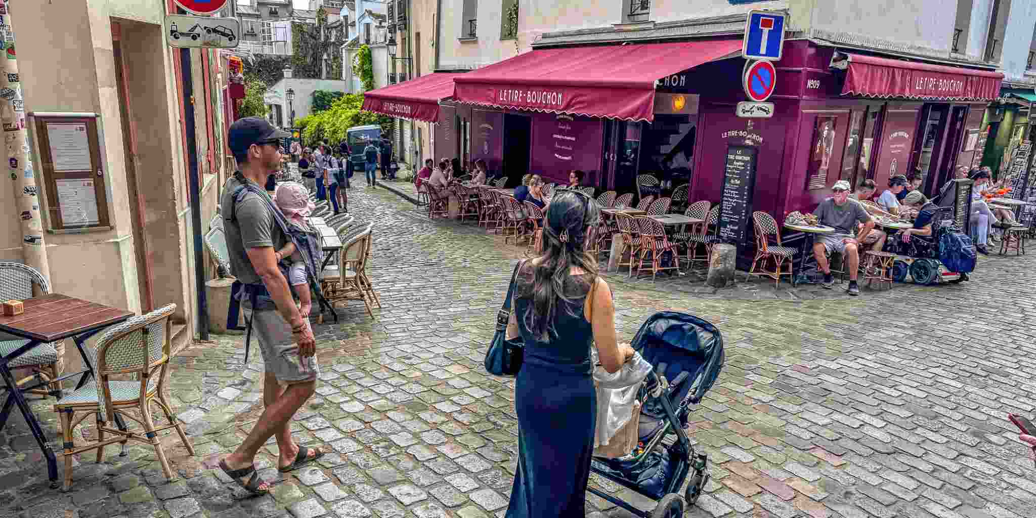 young parents strolling with their children in Paris, France, one of the best countries to move to from the USA with family