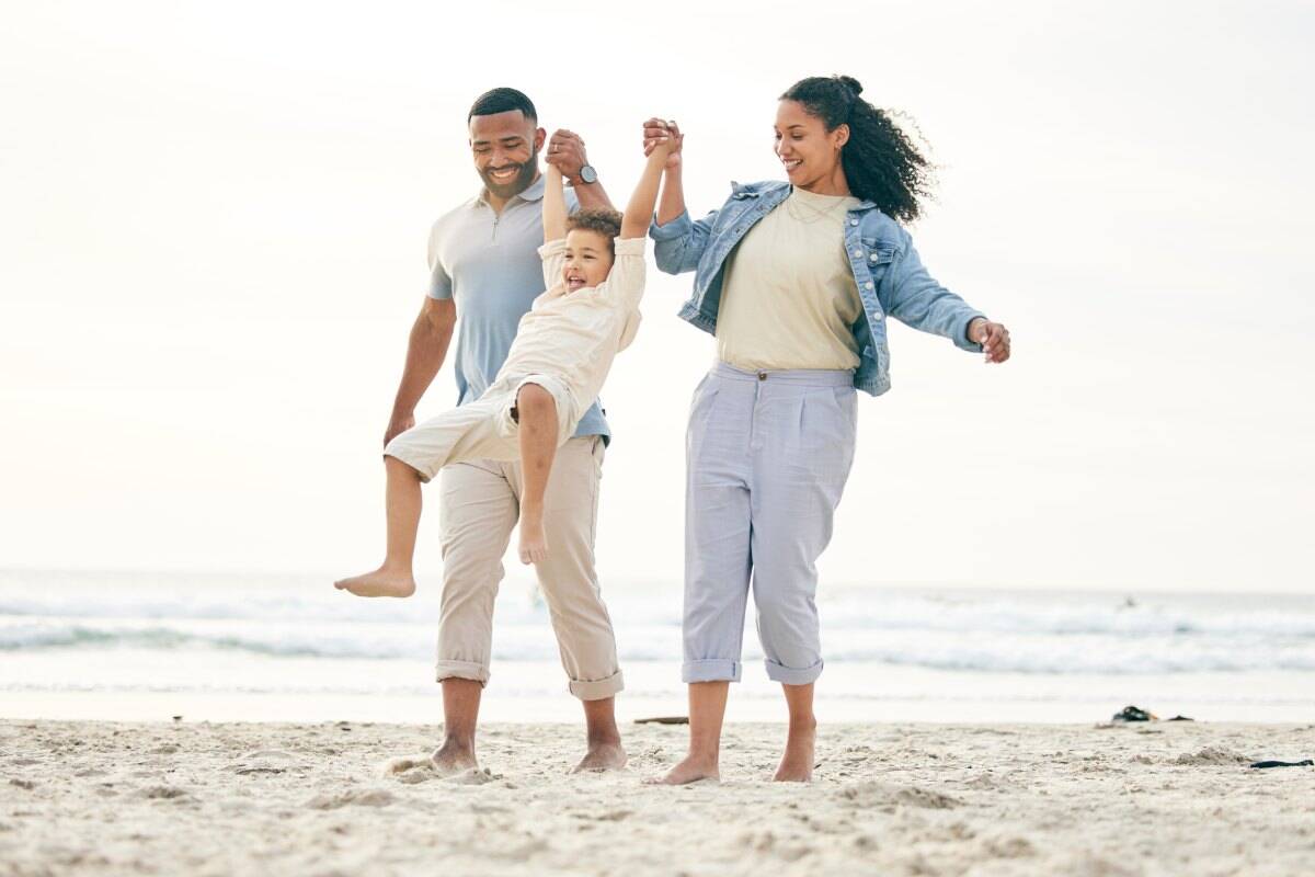Happy family at the beach, showcasing international health insurance options for global travelers and expatriates.