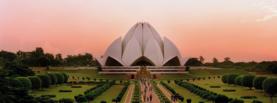 A stunning view of the Lotus Temple with well-maintained gardens, emphasizing global connectivity and the importance of reliable international health insurance coverage.