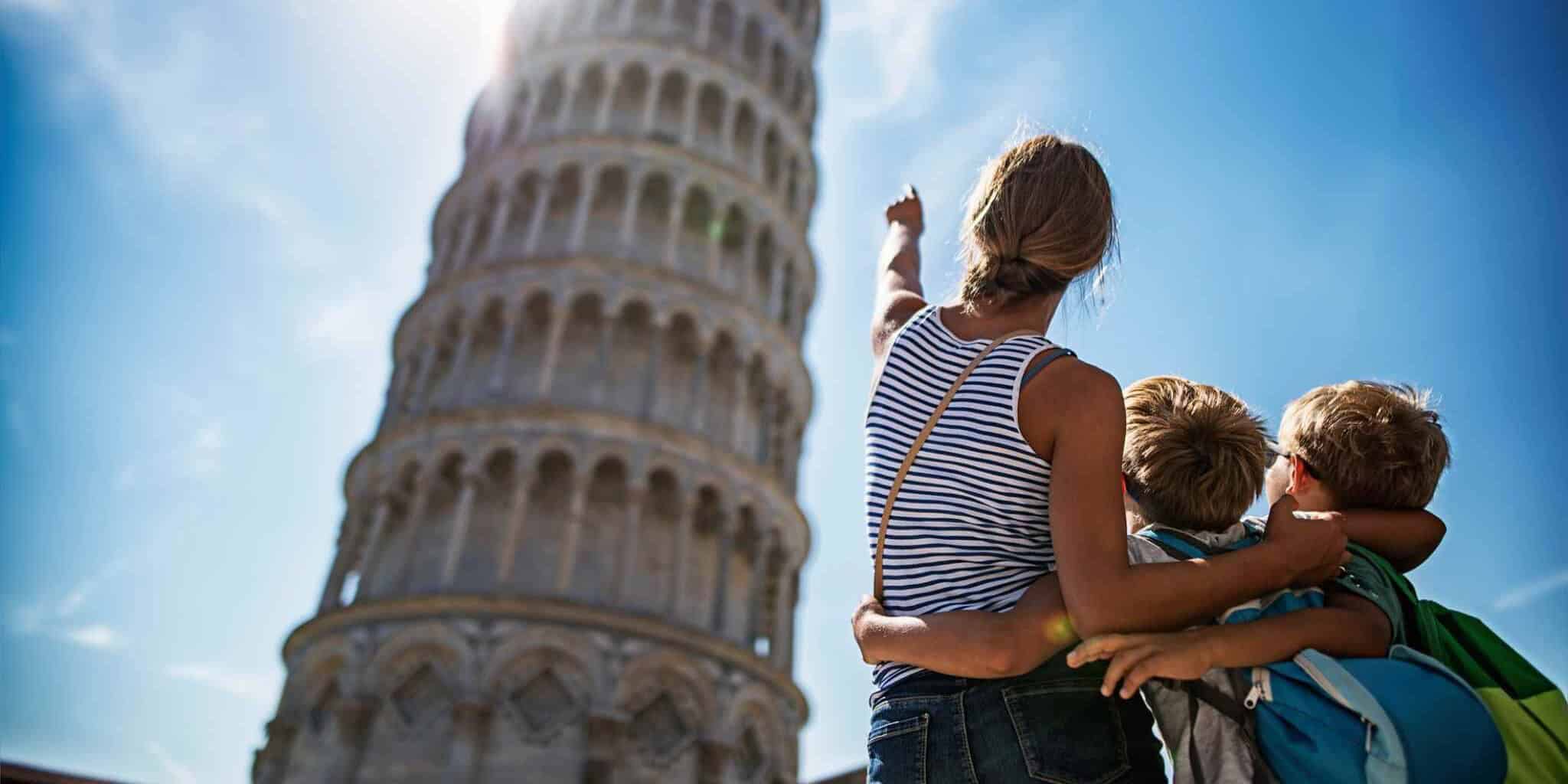 a mother with her two children at the Leaning Tower of Pisa in Italy, ones of the best travel destinations in 2026