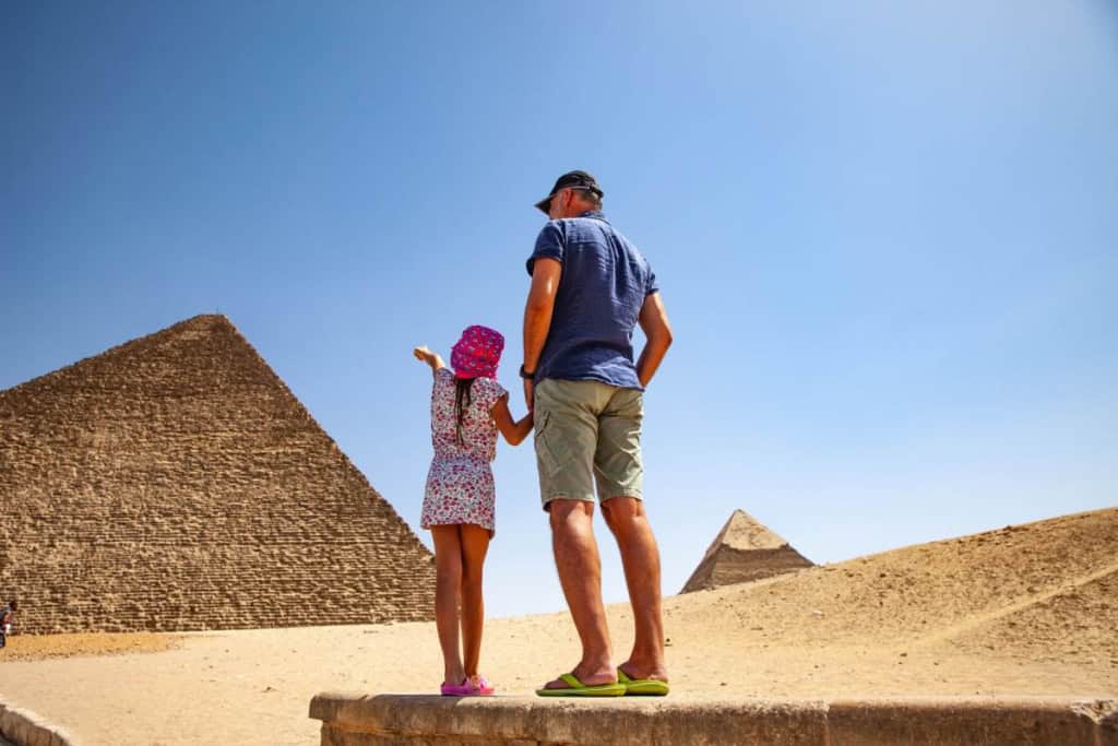 a father and daughter looking at the pyramids in Cairo, one of the best family vacation ideas for 2026