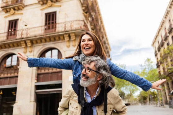 Vibrant moment of a woman and man exploring a city, highlighting the importance of travel insurance for international trips.