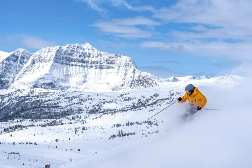 a person skiing in Alberta's Rocky Mountain in Canada, after buying travel insurance for Canada