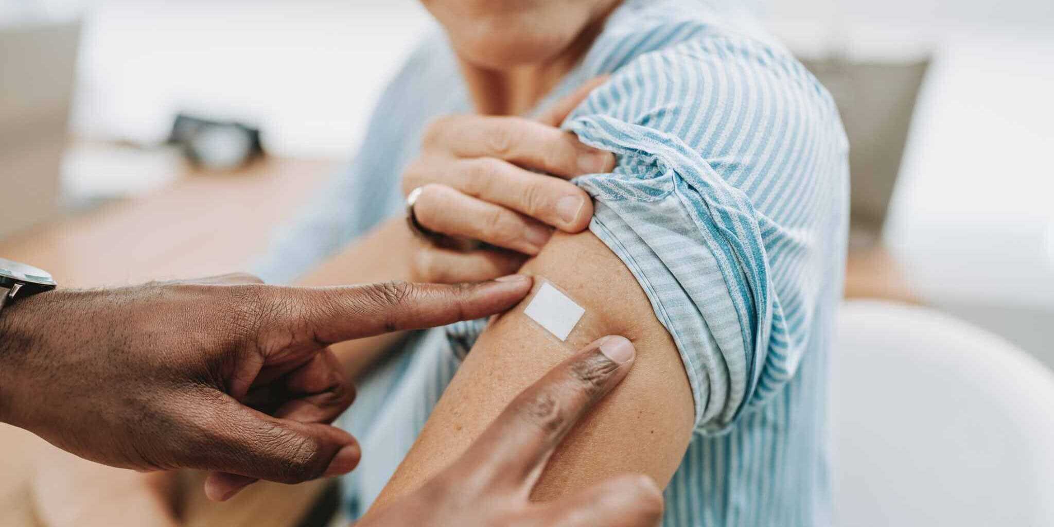 a woman getting vaccination before traveling to Brazil