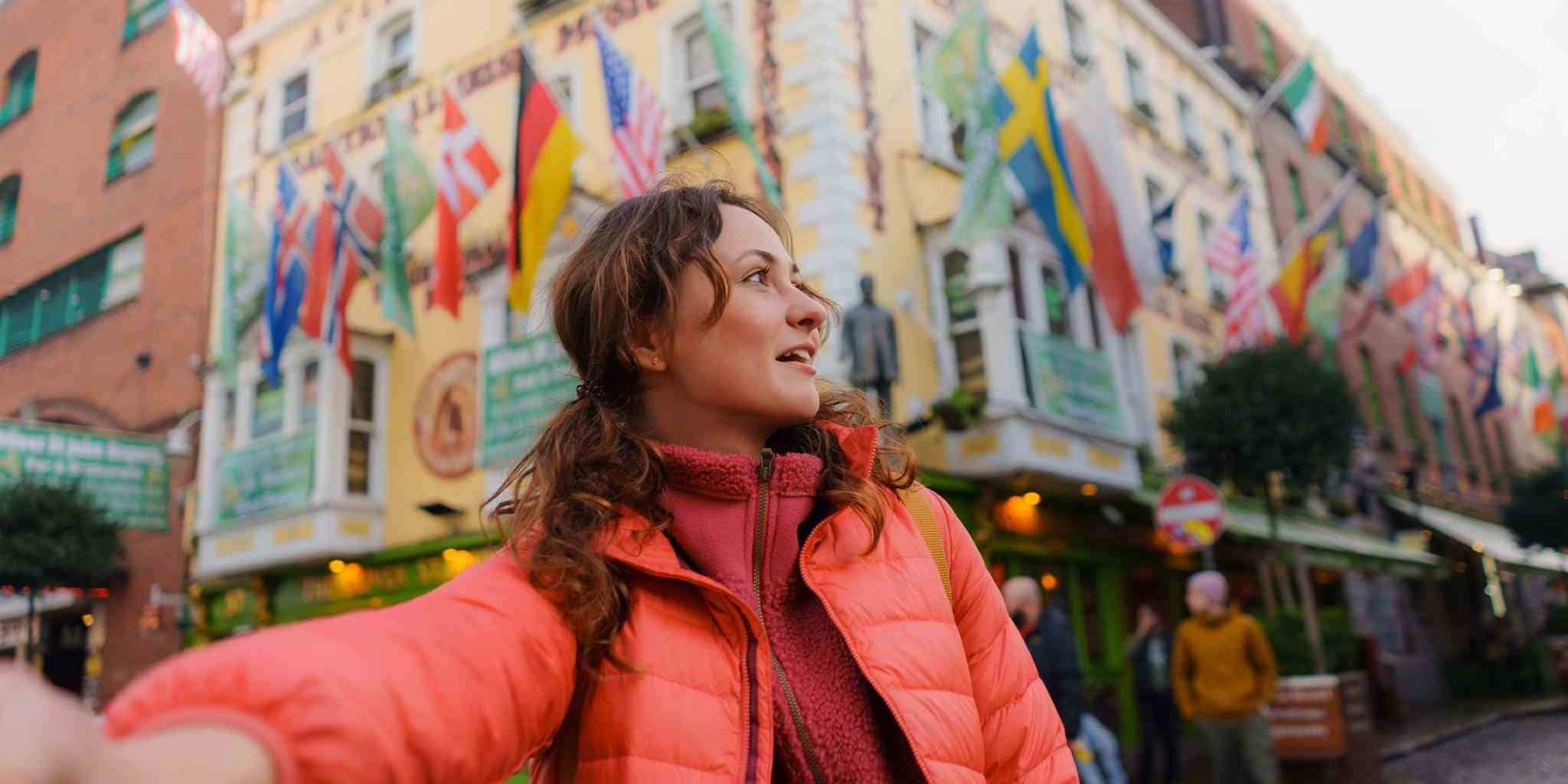 a woman taking a selfie in the middle of Dublin in Ireland