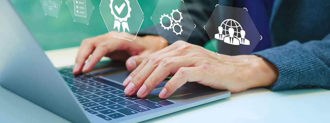 Image shows business professional using a laptop with digital icons representing insurance, certification, and global connectivity.
