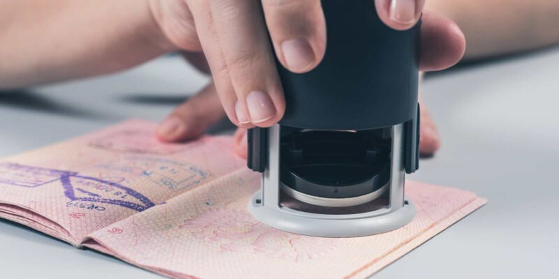 a passport being stamped at immigration and passport control