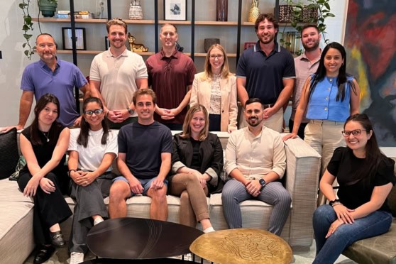 An engaging team photo of diverse professionals in an office, representing international insurance expertise for global citizens.