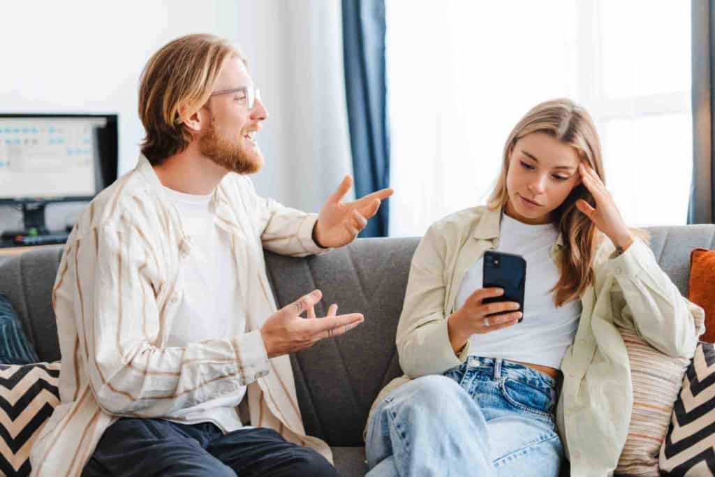 A young woman concerns over health issues, with a man explaining health insurance options, highlighting international health coverage for expatriates and travelers.