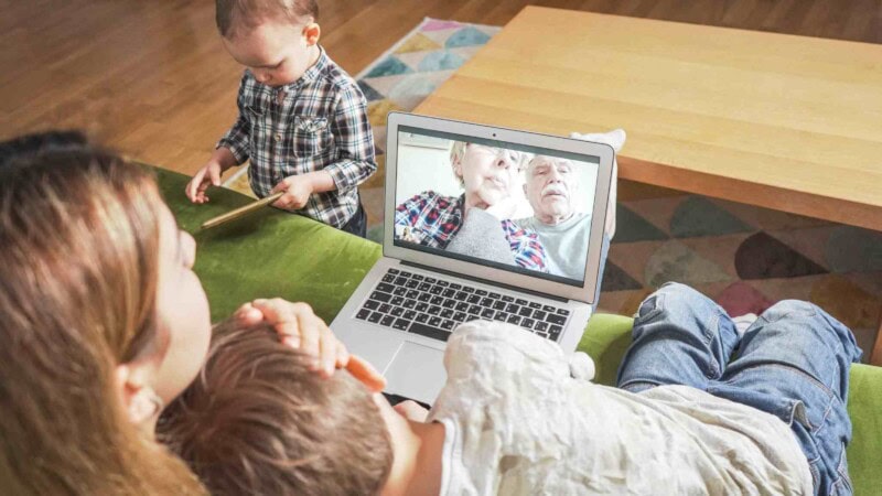 a young mom and sons facetiming with their grandparents 