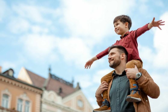 Family enjoying outdoor city scene, highlighting travel insurance for international citizens and protection during global adventures.