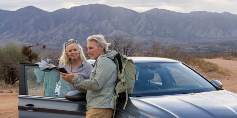 mature couple enjoying a road trip in America, having purchased travel insurance for the USA