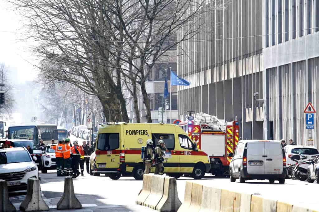 police and vehicles gathering outside a building near European institutions in Brussels, Belgium due to a terrorism bomb threat