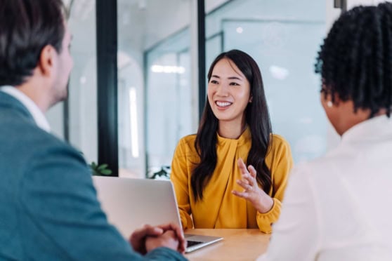 Group of business persons talking in the office, indicating an employee selection process